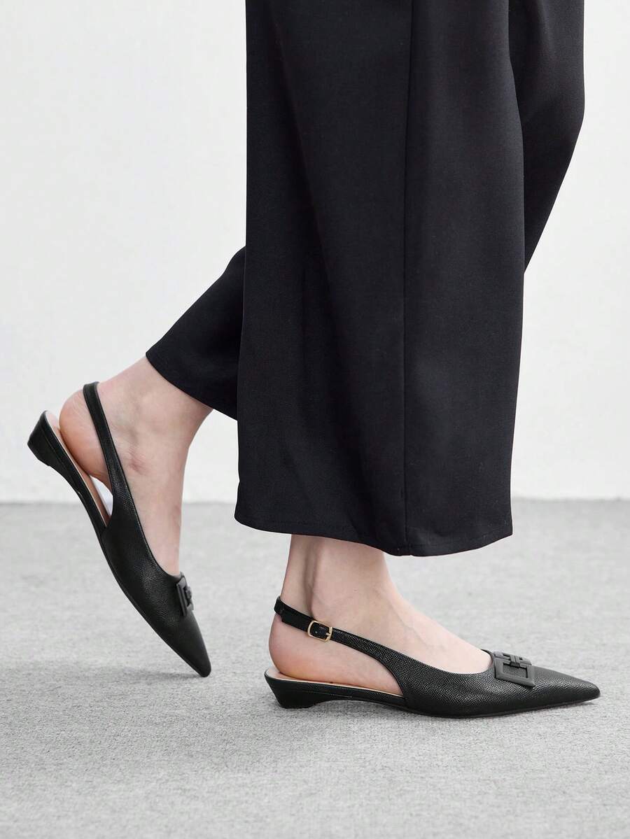 Women's pointed toe low wedge flat shoes crafted in PU leather with a slingback strap and stylish metal buckle detail.