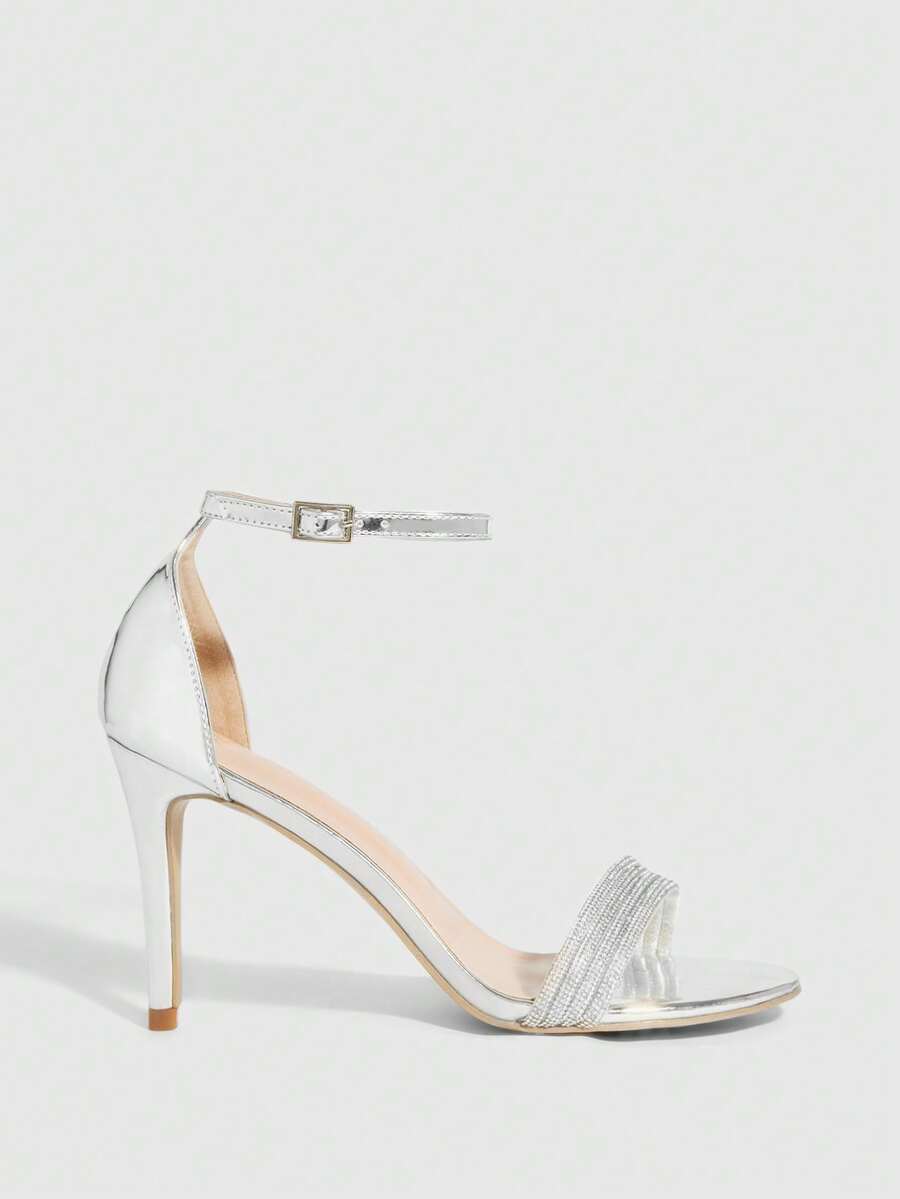 Women's pointed toe high heel sandals with sparkling rhinestone ankle straps and stiletto heels for evening and party wear.