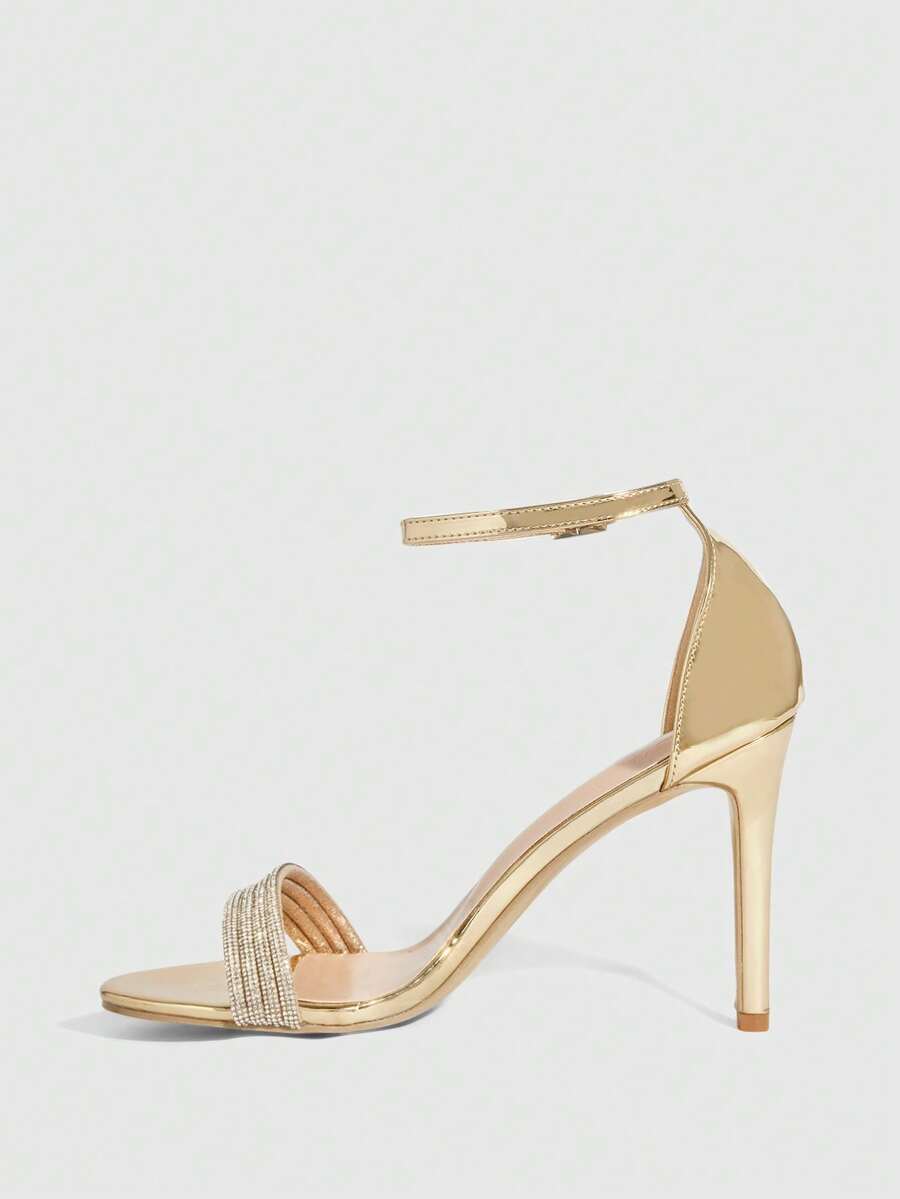 Women's pointed toe high heel sandals with sparkling rhinestone ankle straps and stiletto heels for evening and party wear.