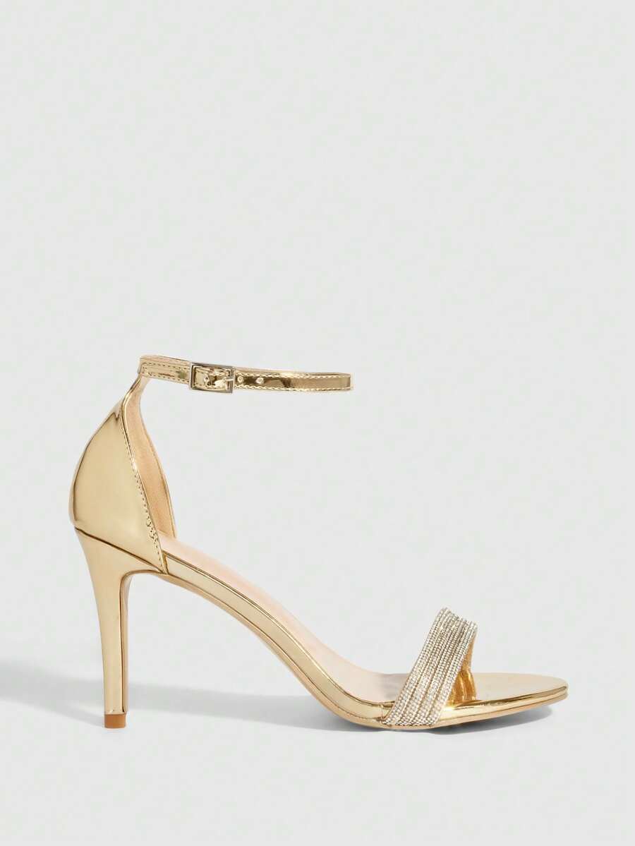 Women's pointed toe high heel sandals with sparkling rhinestone ankle straps and stiletto heels for evening and party wear.