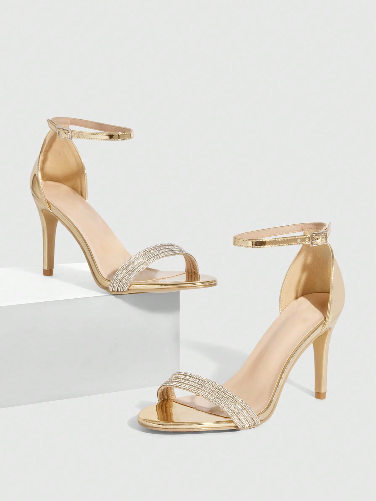 Women's pointed toe high heel sandals with sparkling rhinestone ankle straps and stiletto heels for evening and party wear.
