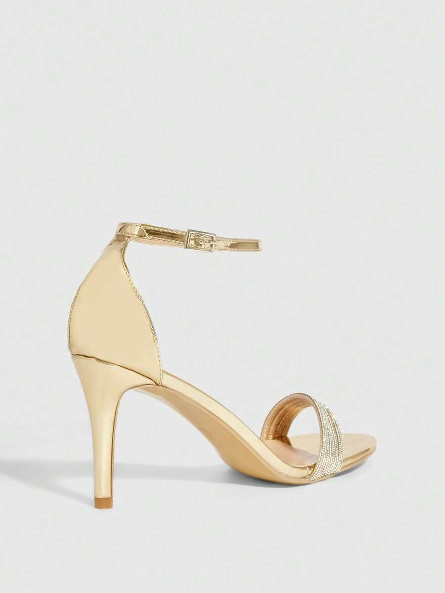 Women's pointed toe high heel sandals with sparkling rhinestone ankle straps and stiletto heels for evening and party wear.