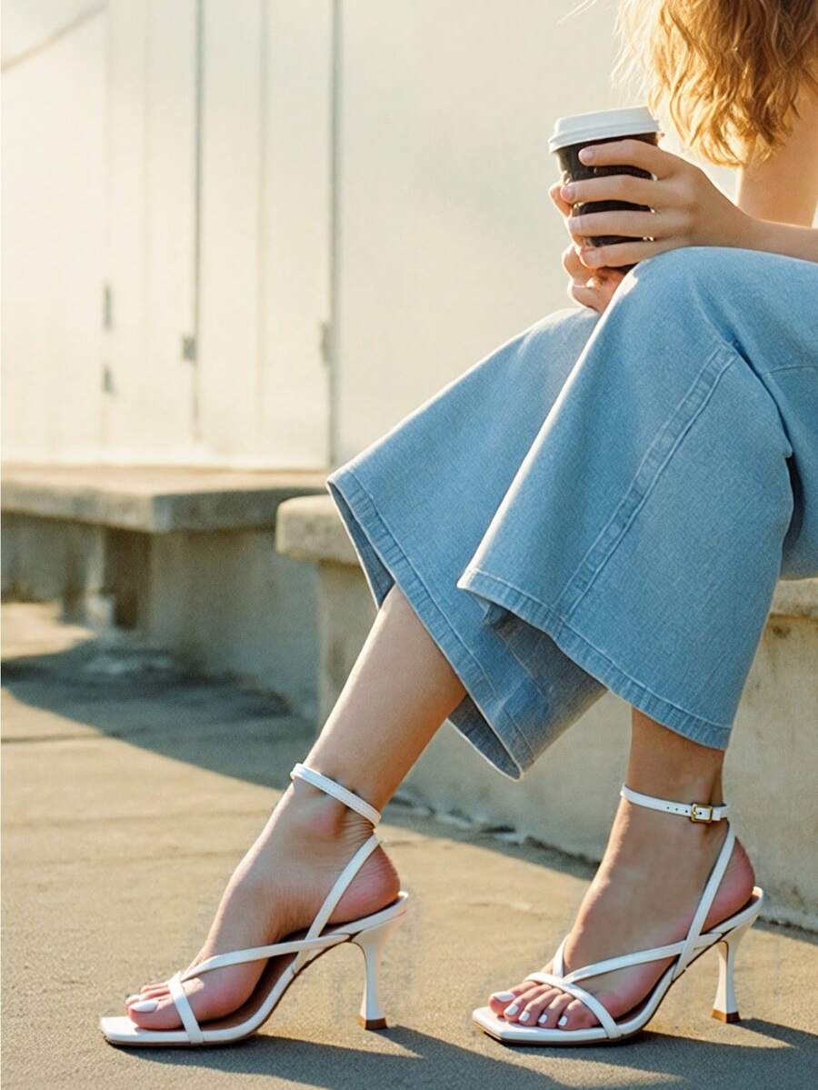 Open square toe kitten heel thong sandals with delicate cross-over straps and an adjustable ankle buckle strap.