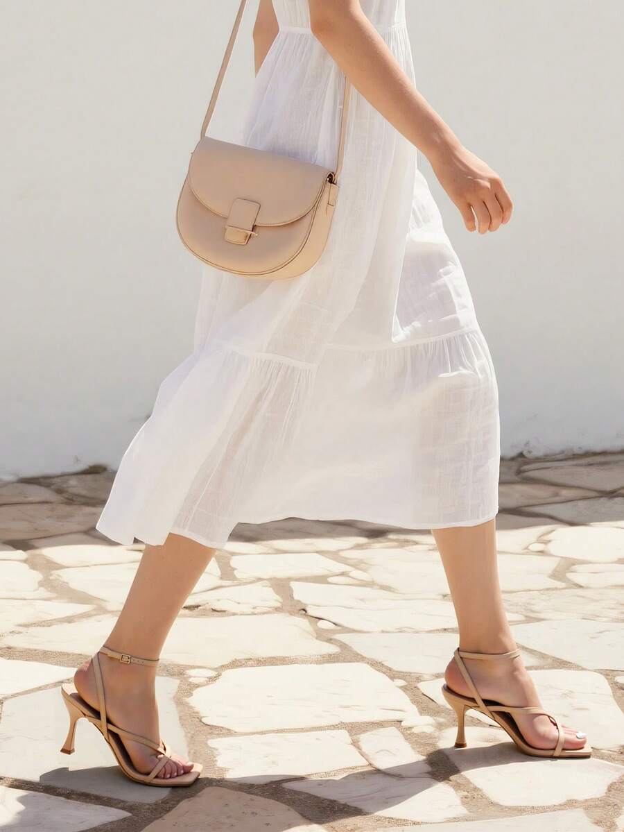 Open square toe kitten heel thong sandals with delicate cross-over straps and an adjustable ankle buckle strap.