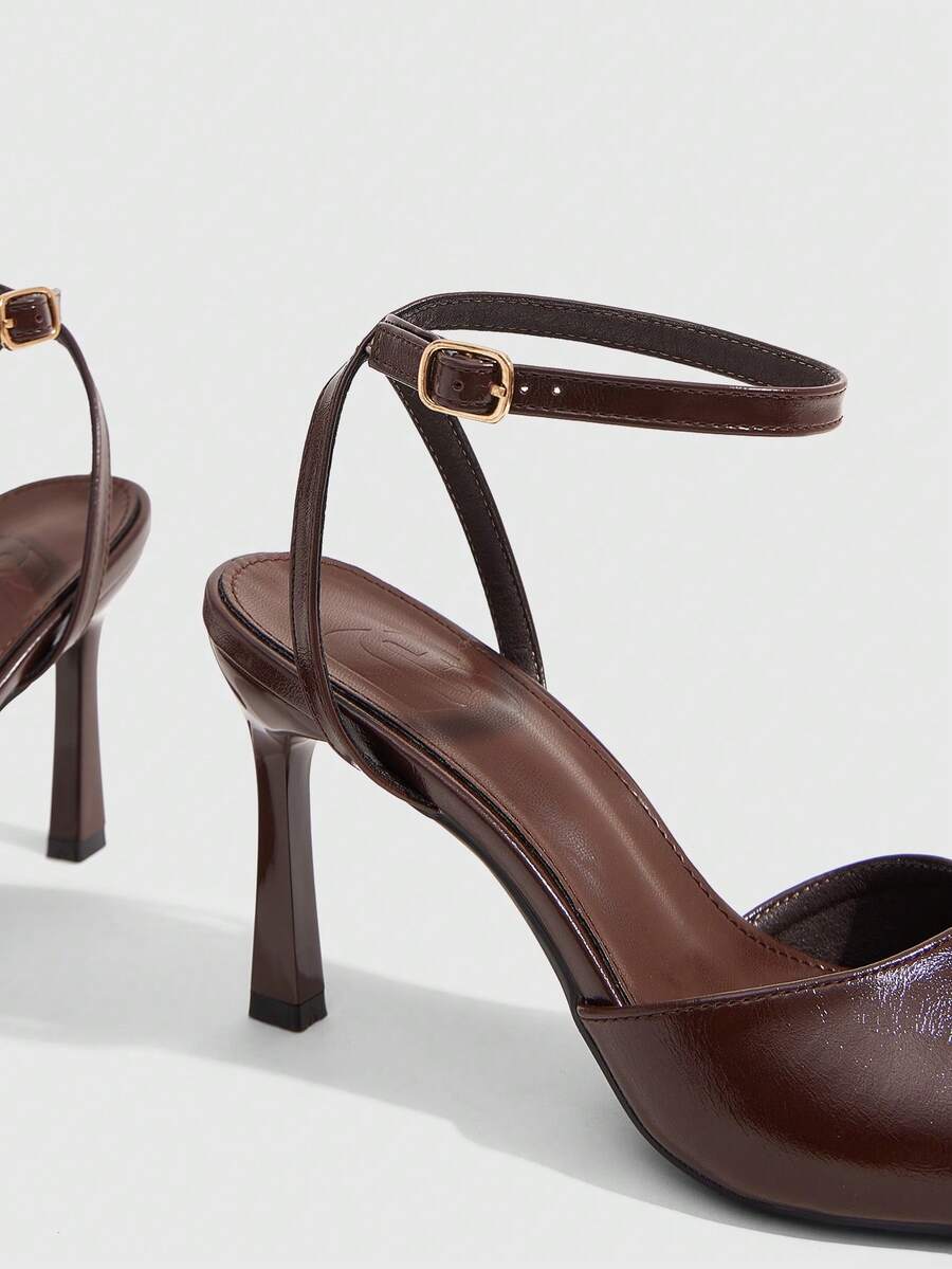 Minimalist women's open toe high heel sandals featuring a slender stiletto heel and adjustable ankle strap buckle closure.