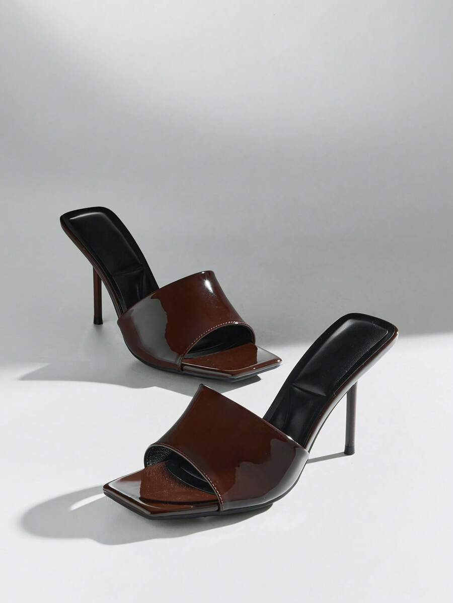 Women's pointed toe stiletto high heel wedding shoes featuring an elegant silhouette and glossy finish.