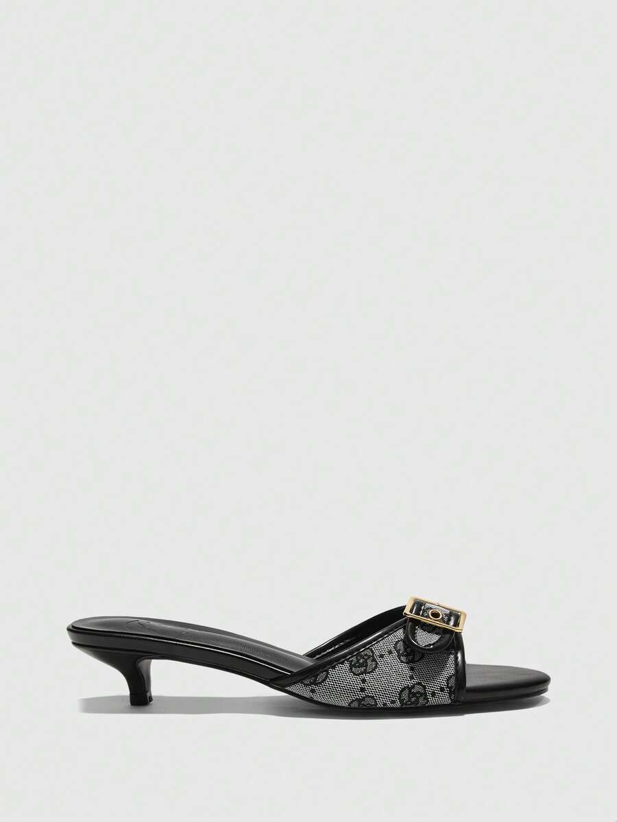 Beige women's slip-on kitten heel slide sandals featuring an accent buckle with grommet eyelets.