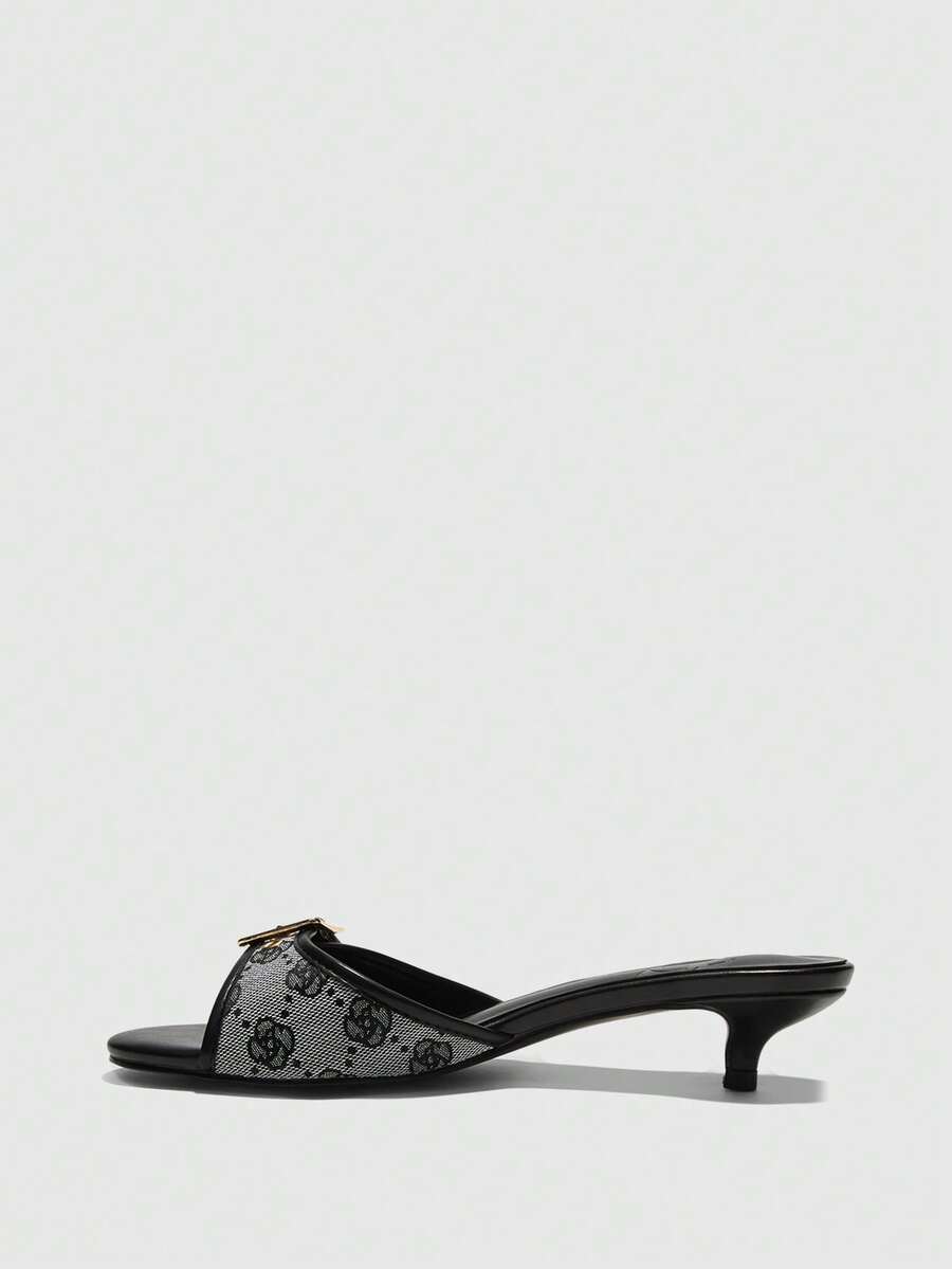 Beige women's slip-on kitten heel slide sandals featuring an accent buckle with grommet eyelets.