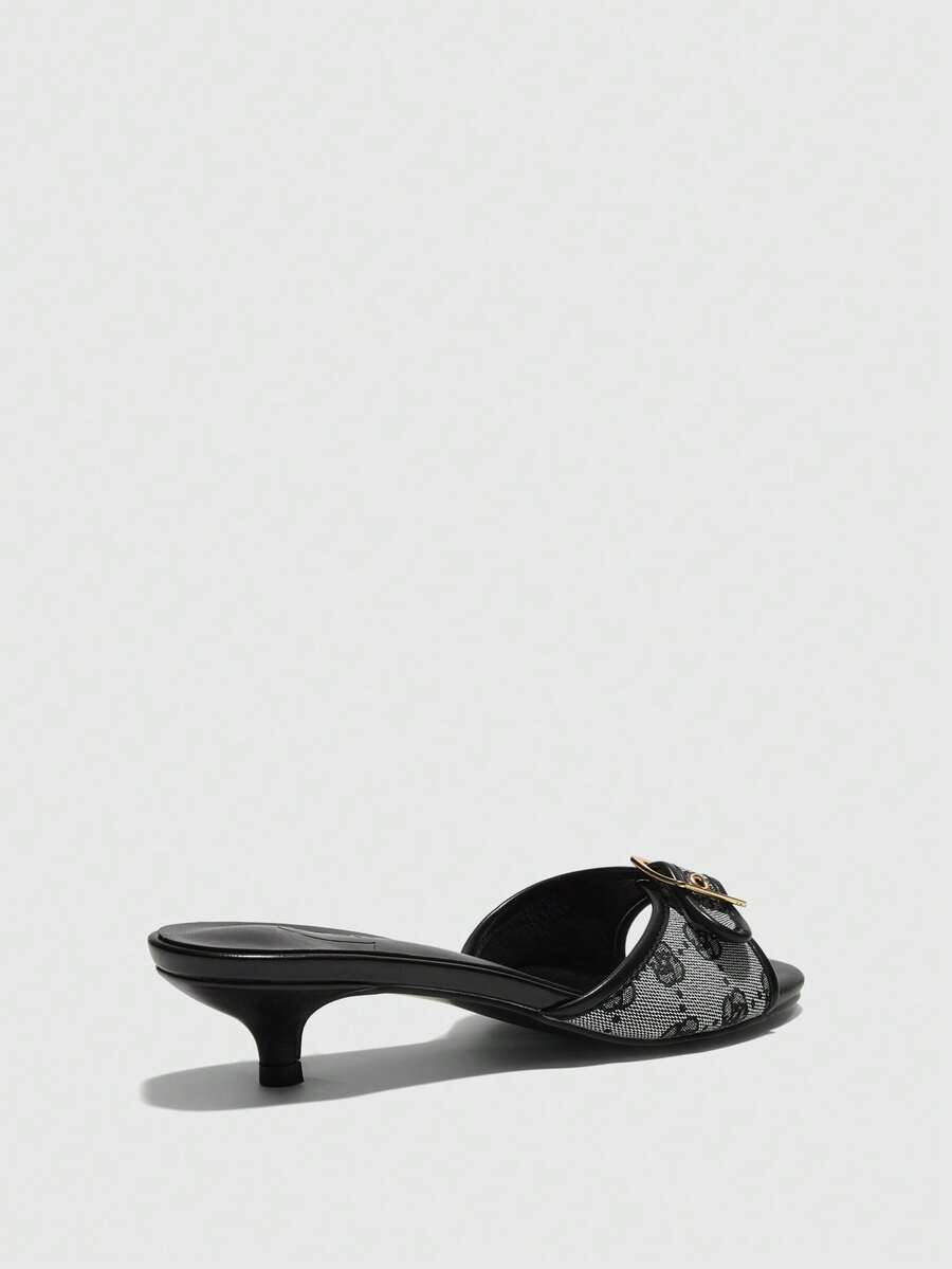 Beige women's slip-on kitten heel slide sandals featuring an accent buckle with grommet eyelets.
