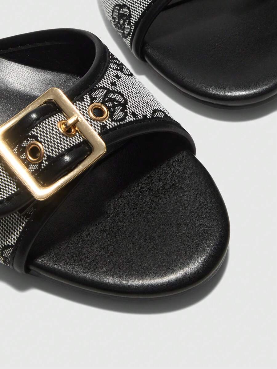 Beige women's slip-on kitten heel slide sandals featuring an accent buckle with grommet eyelets.