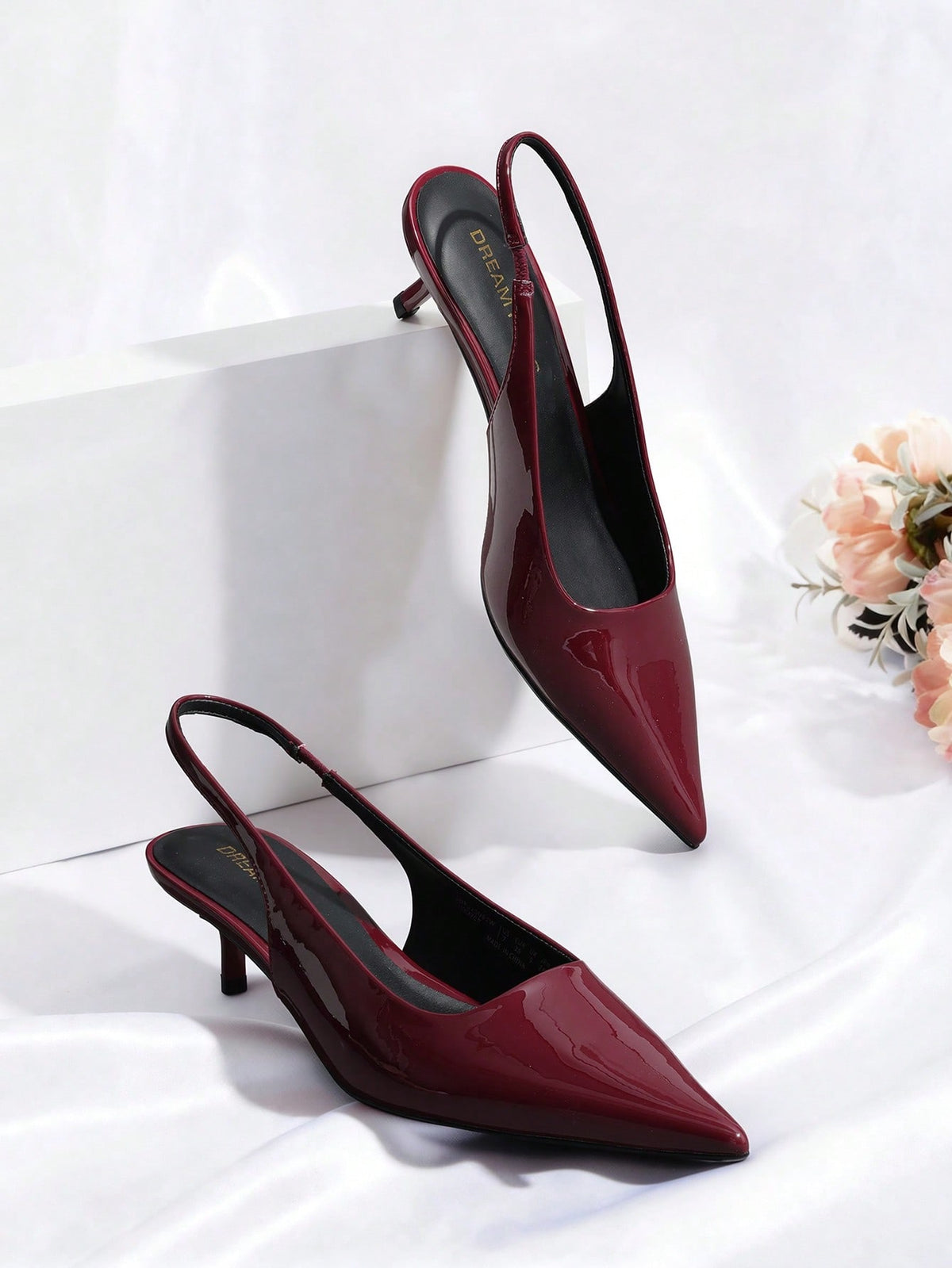 Pointed toe slingback kitten heel pumps in burgundy patent leather with low heel and slip-on strap for women