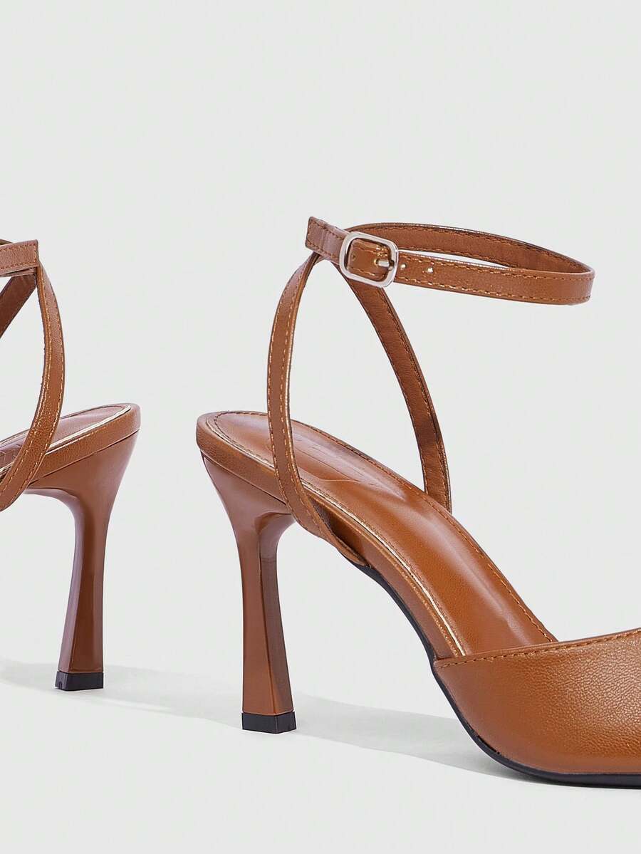 Minimalist women's open toe high heel sandals featuring a slender stiletto heel and adjustable ankle strap buckle closure.