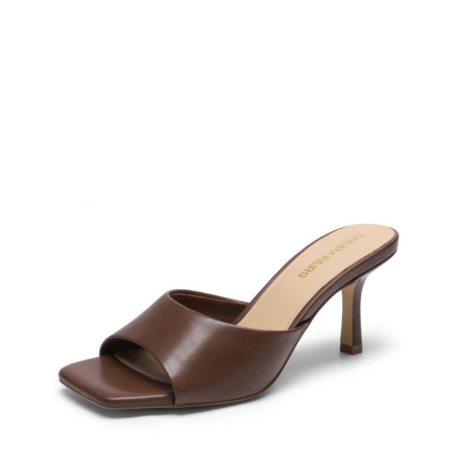Pair of women's open square toe kitten heel mule sandals in white PU leather with slip-on styling.