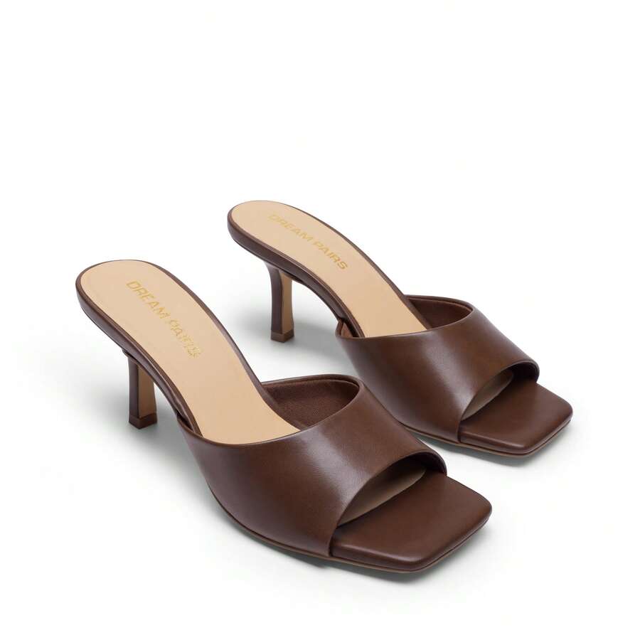 Pair of women's open square toe kitten heel mule sandals in white PU leather with slip-on styling.
