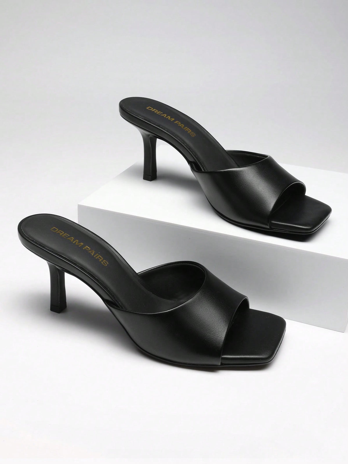 Pair of women's open square toe kitten heel mule sandals in white PU leather with slip-on styling.