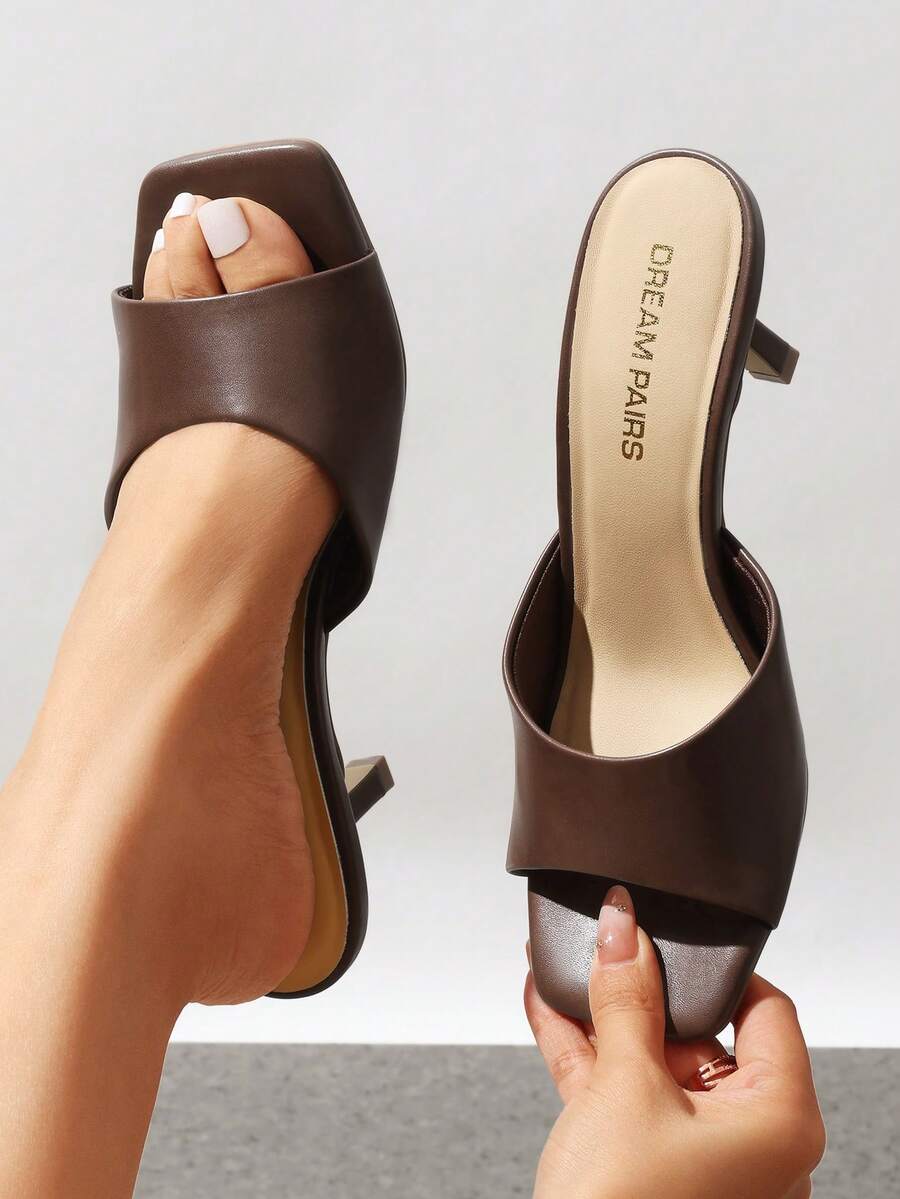 Pair of women's open square toe kitten heel mule sandals in white PU leather with slip-on styling.