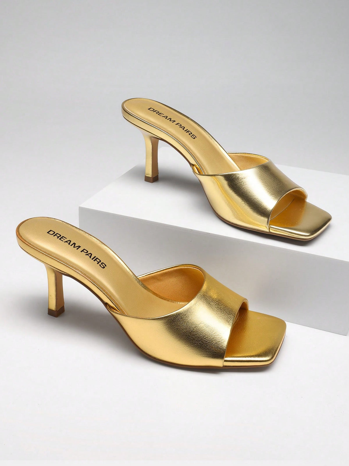 Pair of women's open square toe kitten heel mule sandals in white PU leather with slip-on styling.
