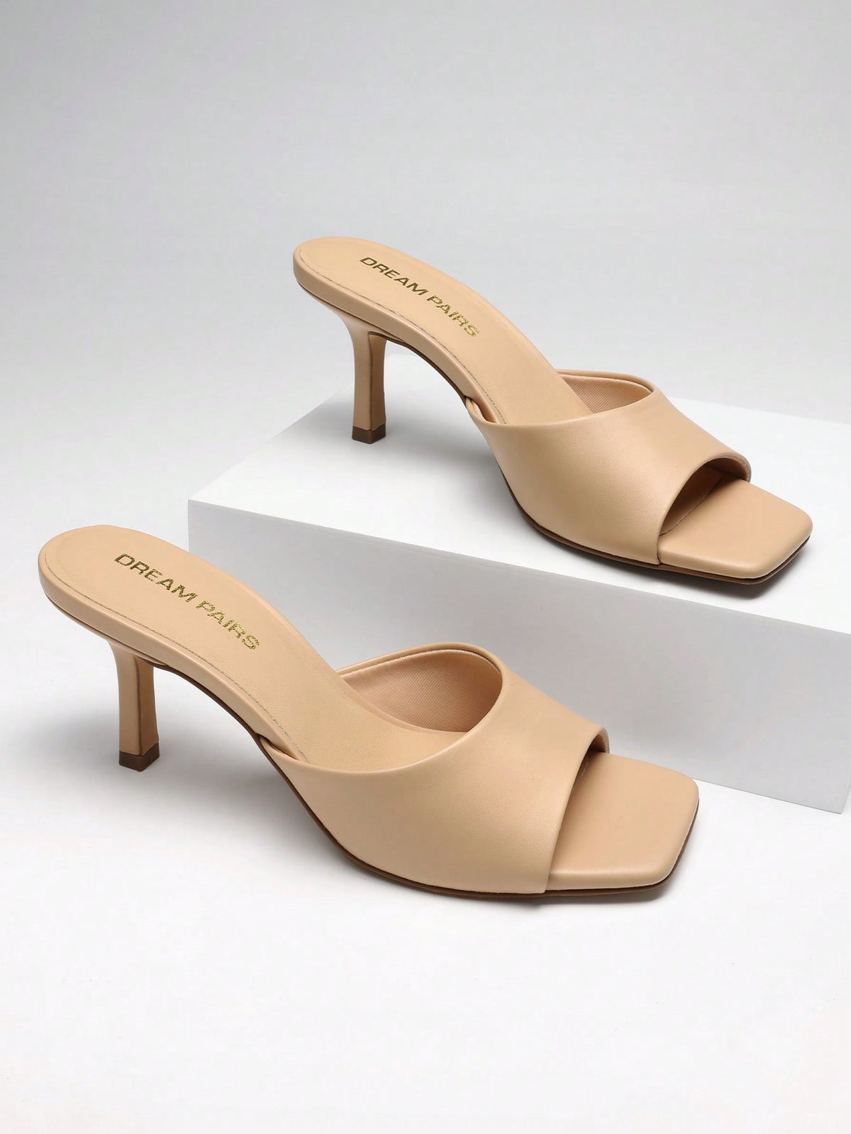 Pair of women's open square toe kitten heel mule sandals in white PU leather with slip-on styling.