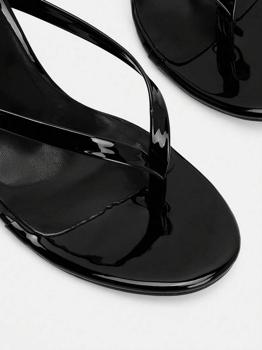Women's black high heel thong sandals with stiletto heel and open round toe design.