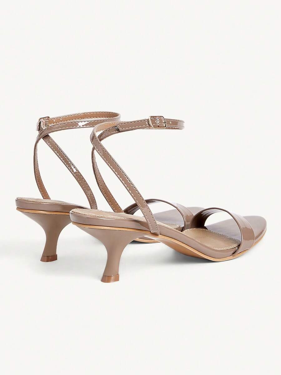 Women's open-toed high-heeled sandals featuring a 5.5cm kitten heel stiletto, sleek ankle strap with buckle closure, and smooth PU leather finish.