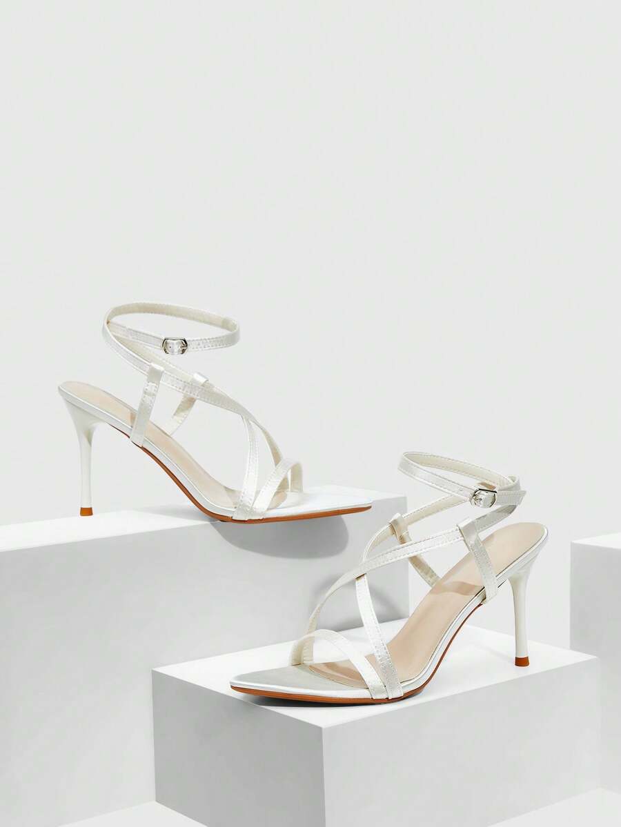 Women's square toe high heel sandals featuring crystal embellishments and crossover ankle straps with buckle closure