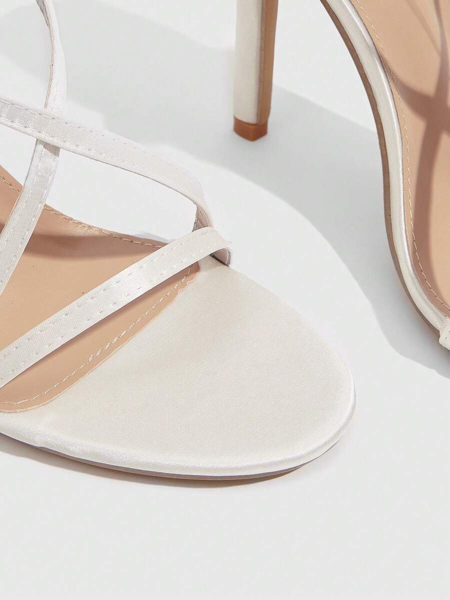 Women's square toe high heel sandals featuring crystal embellishments and crossover ankle straps with buckle closure