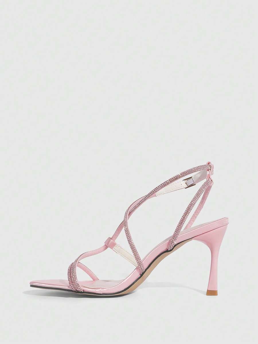 Women's pointed toe high heel sandals embellished with sparkling rhinestones, stiletto heels, and ankle strap buckle closure.