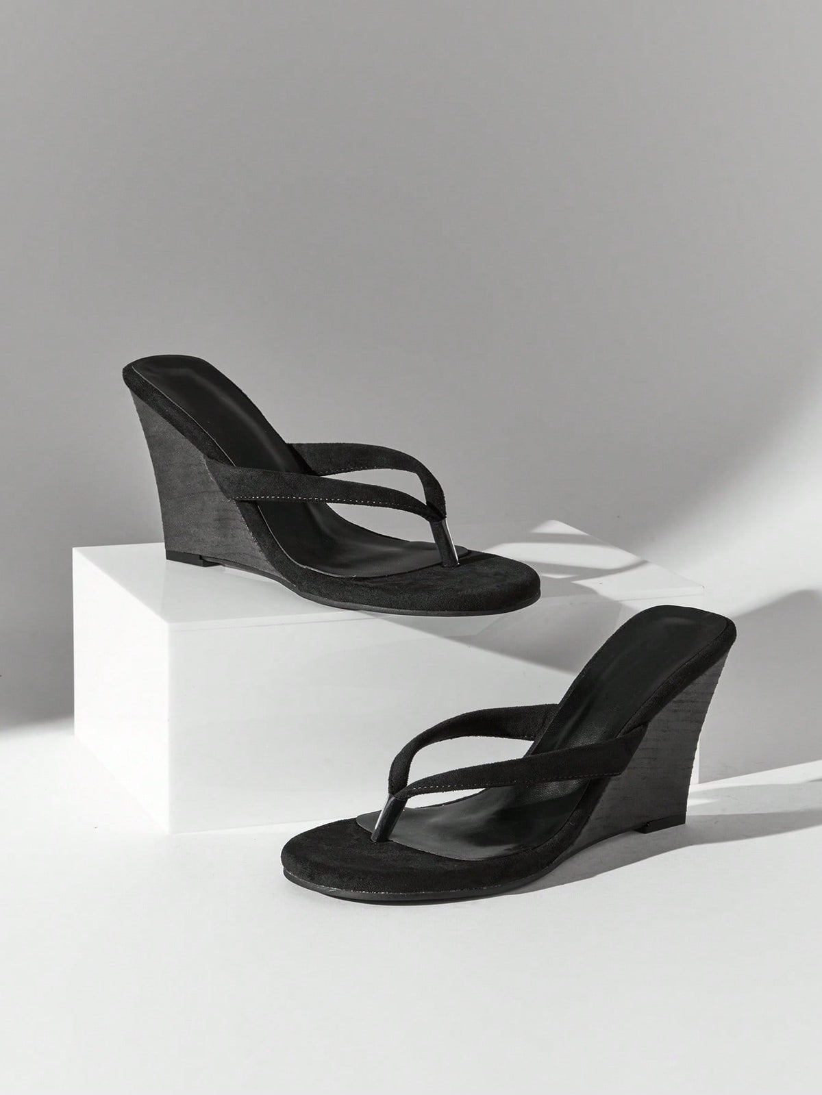 Women's faux suede thong wedge sandals featuring rope detail and high platform wedge sole