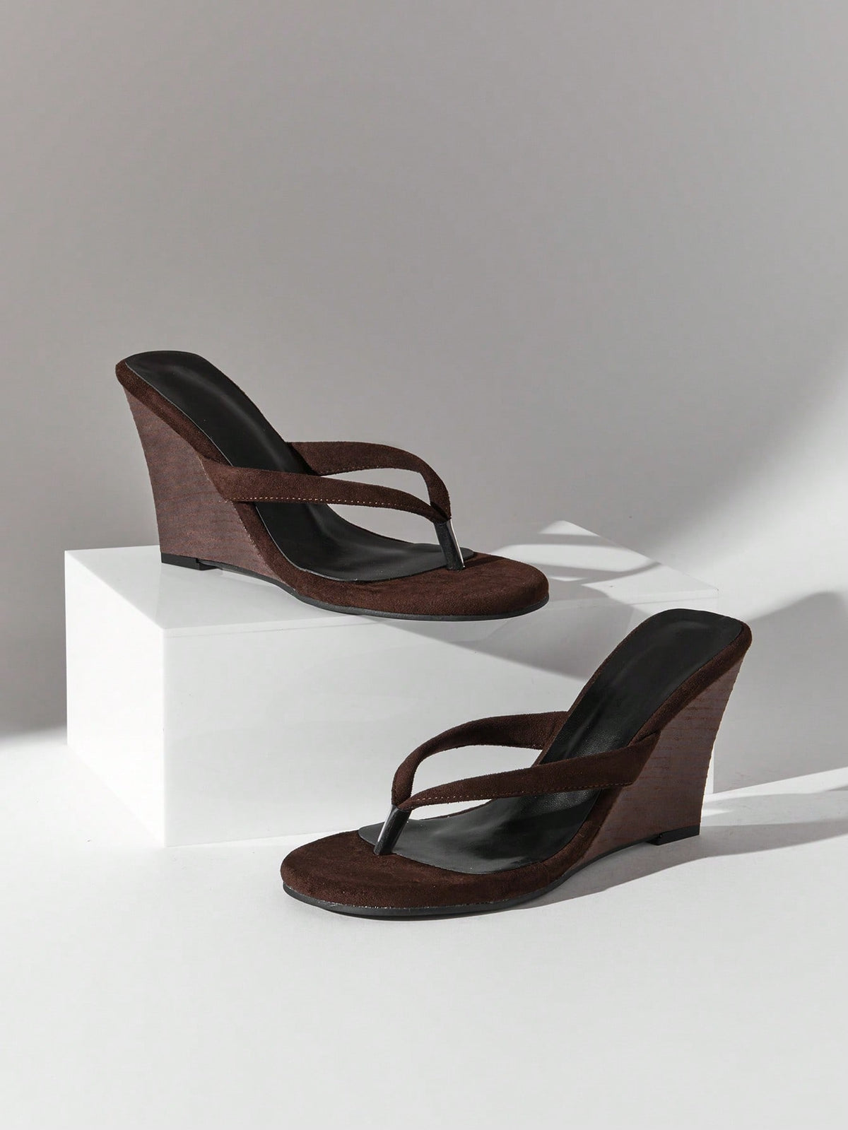 Women's faux suede thong wedge sandals featuring rope detail and high platform wedge sole