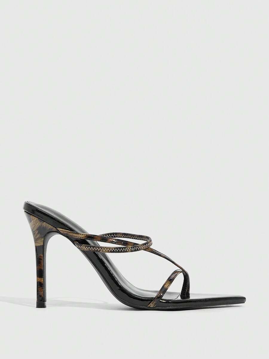 Women's pointed toe heeled sandals with criss cross straps and high stiletto heels.