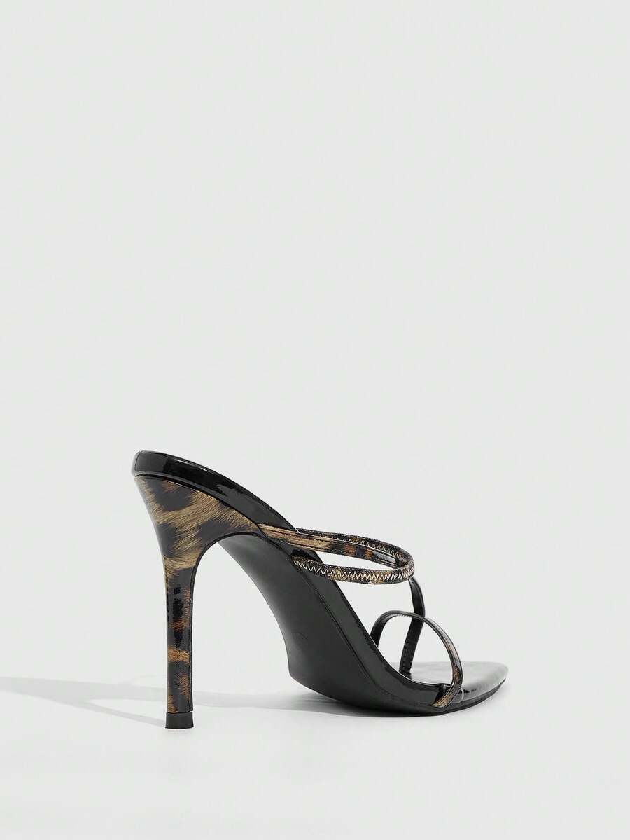 Women's pointed toe heeled sandals with criss cross straps and high stiletto heels.