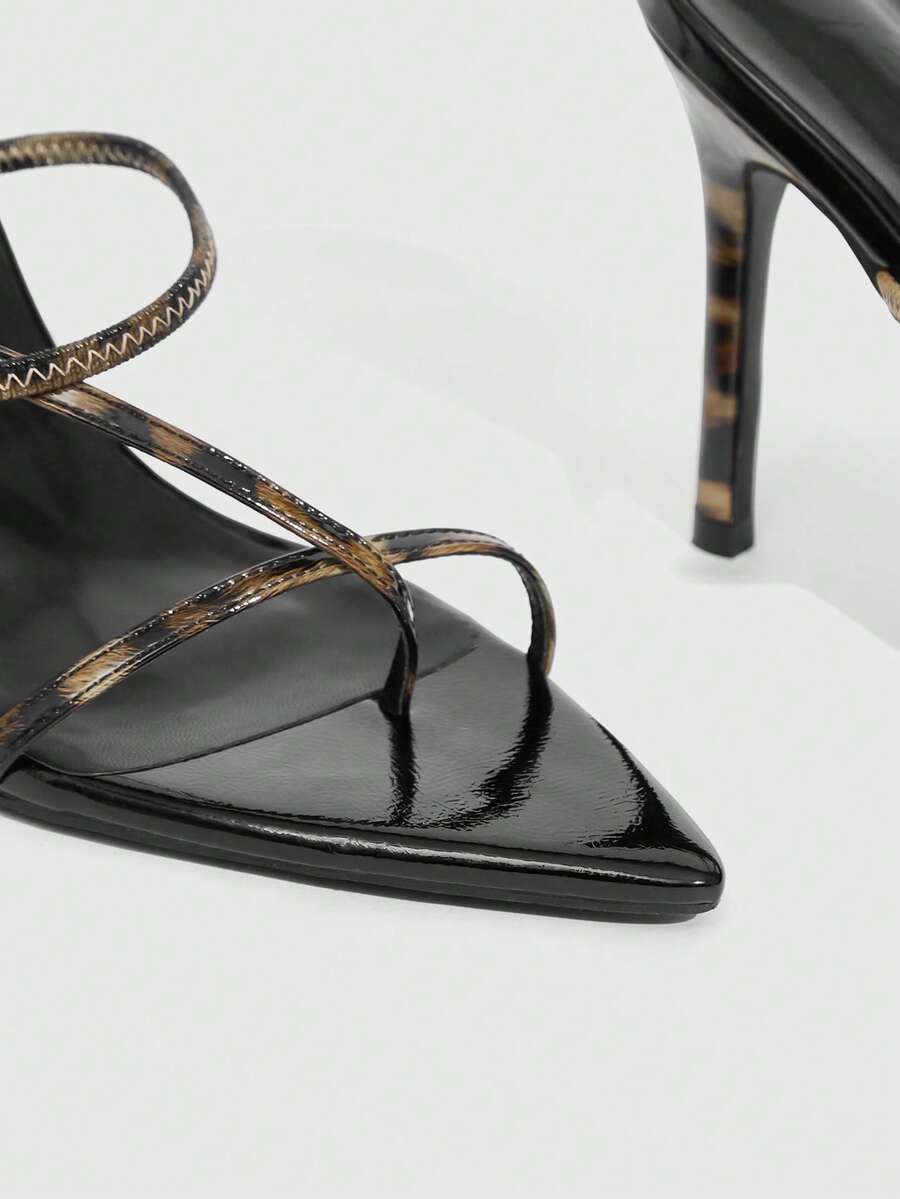 Women's pointed toe heeled sandals with criss cross straps and high stiletto heels.