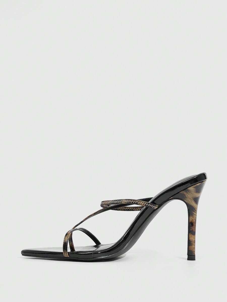 Women's pointed toe heeled sandals with criss cross straps and high stiletto heels.