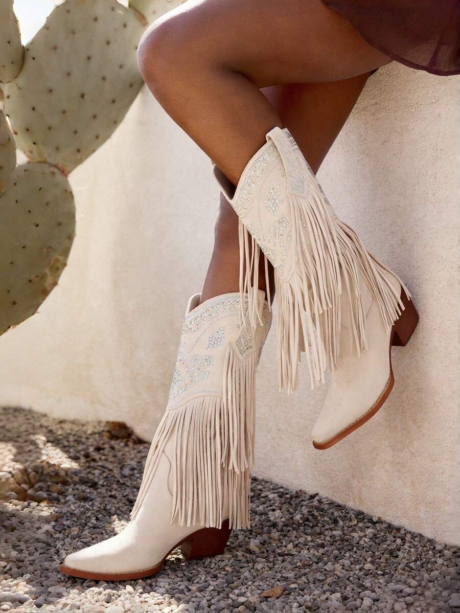 Women's camel suedette knee high western cowgirl boots featuring sparkling rhinestone fringe accents, a pointed toe, and a chunky block heel.