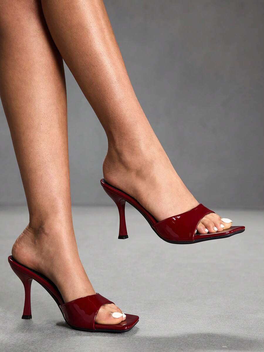 Women's open square toe slender high heel sandals with slingback strap and metal buckle detailing.