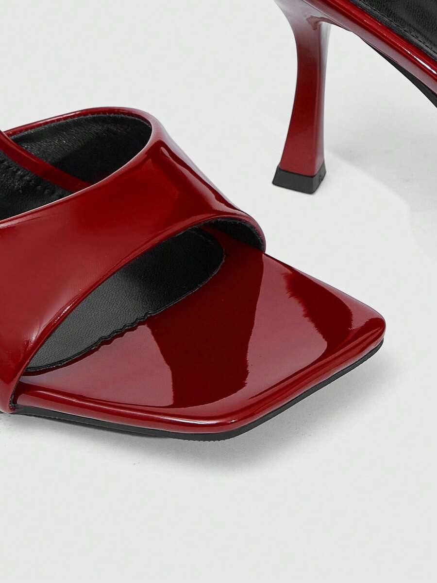Women's open square toe slender high heel sandals with slingback strap and metal buckle detailing.