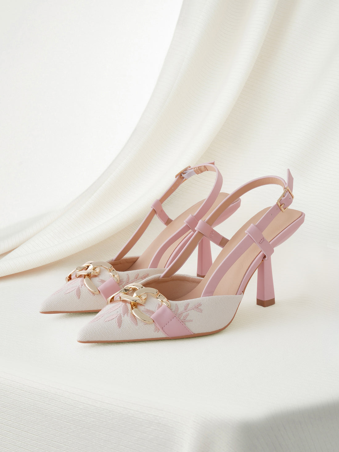 Baby pink embroidered pointed toe slingback high heel sandals with gold chain accent and stiletto heel