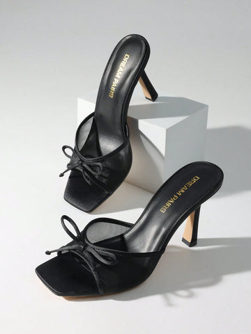 Women's open toe stiletto mule sandals featuring a breathable mesh upper with a decorative bow and square toe design.
