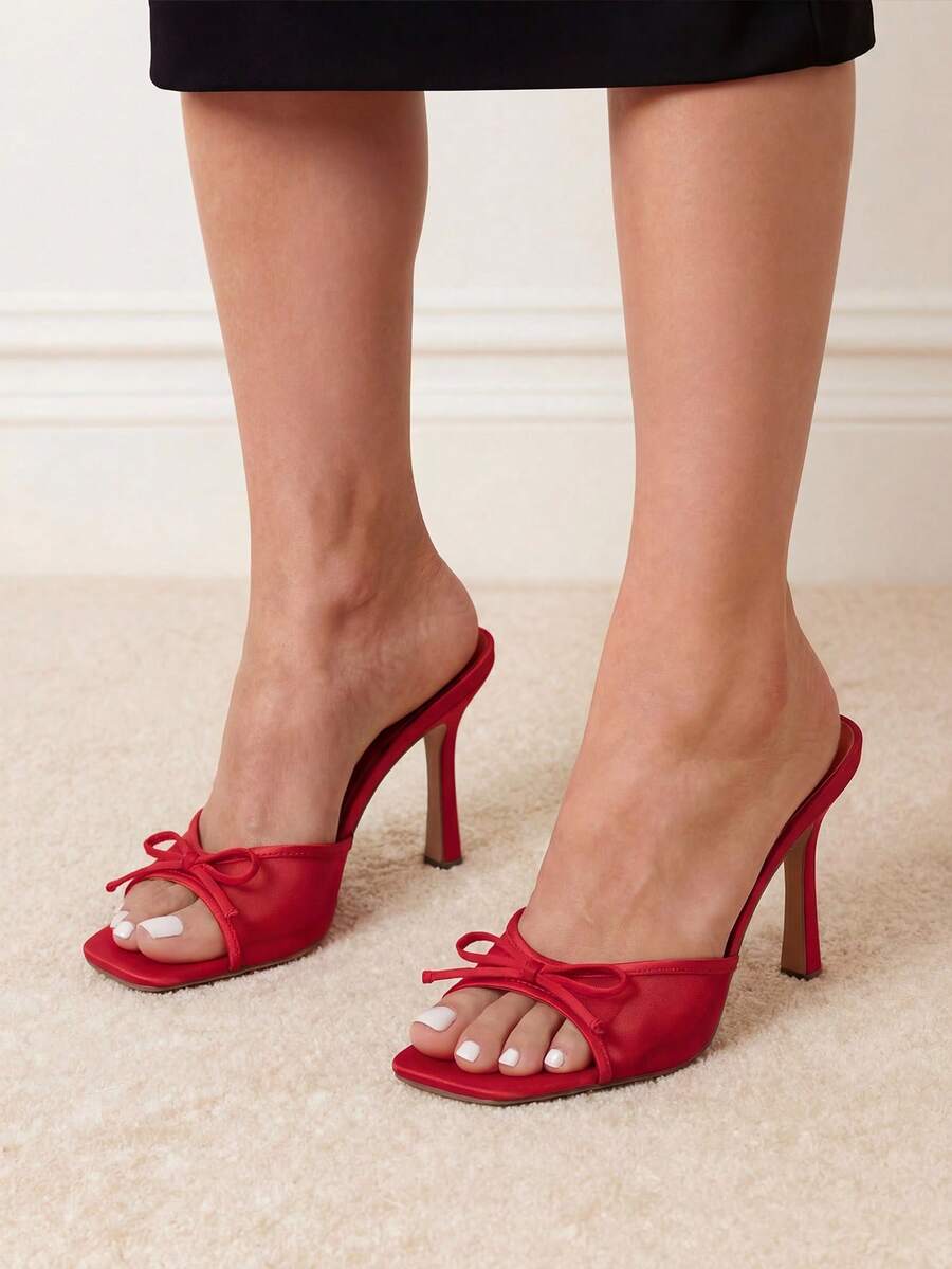Women's open toe stiletto mule sandals featuring a breathable mesh upper with a decorative bow and square toe design.