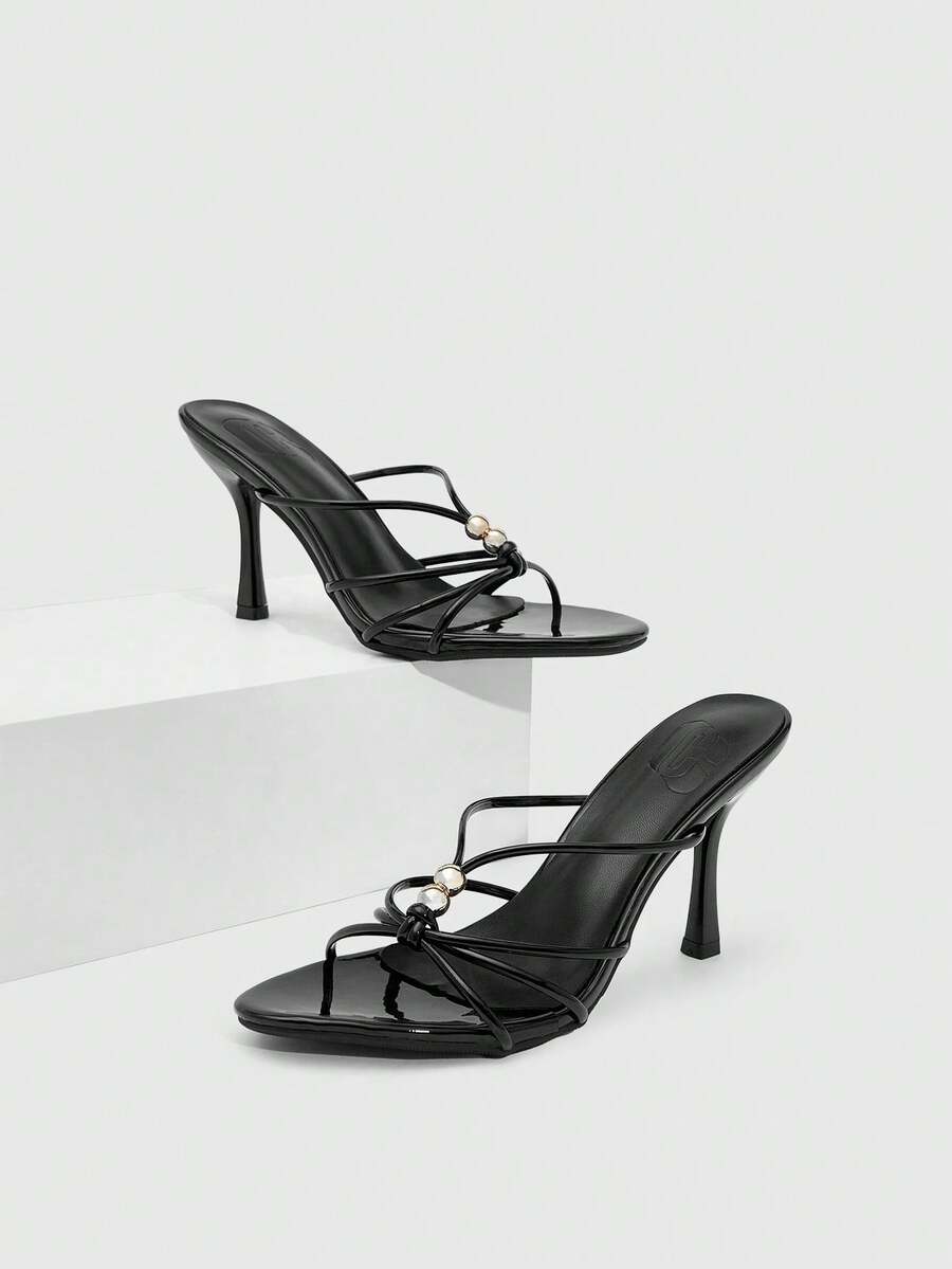 Burgundy stiletto high heel sandals featuring open toe thin straps and knot details
