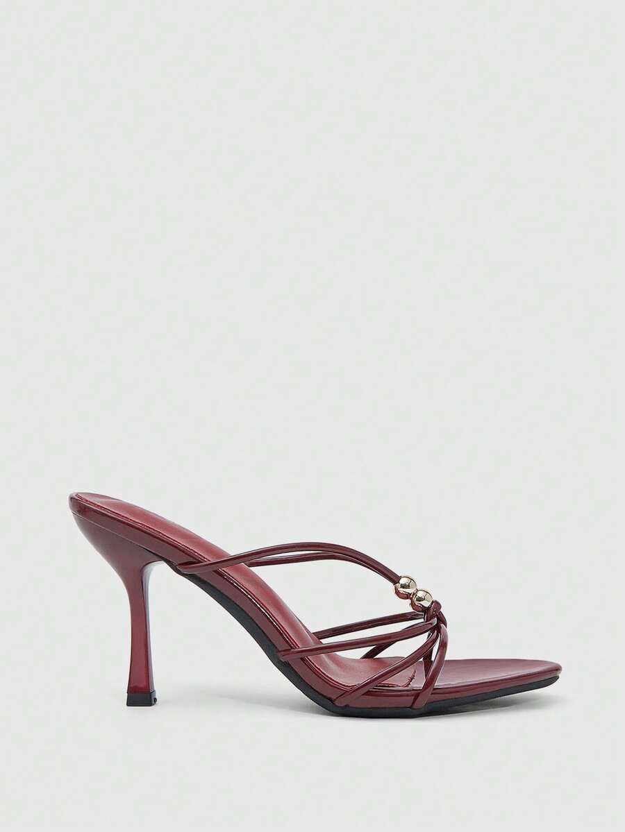 Burgundy stiletto high heel sandals featuring open toe thin straps and knot details