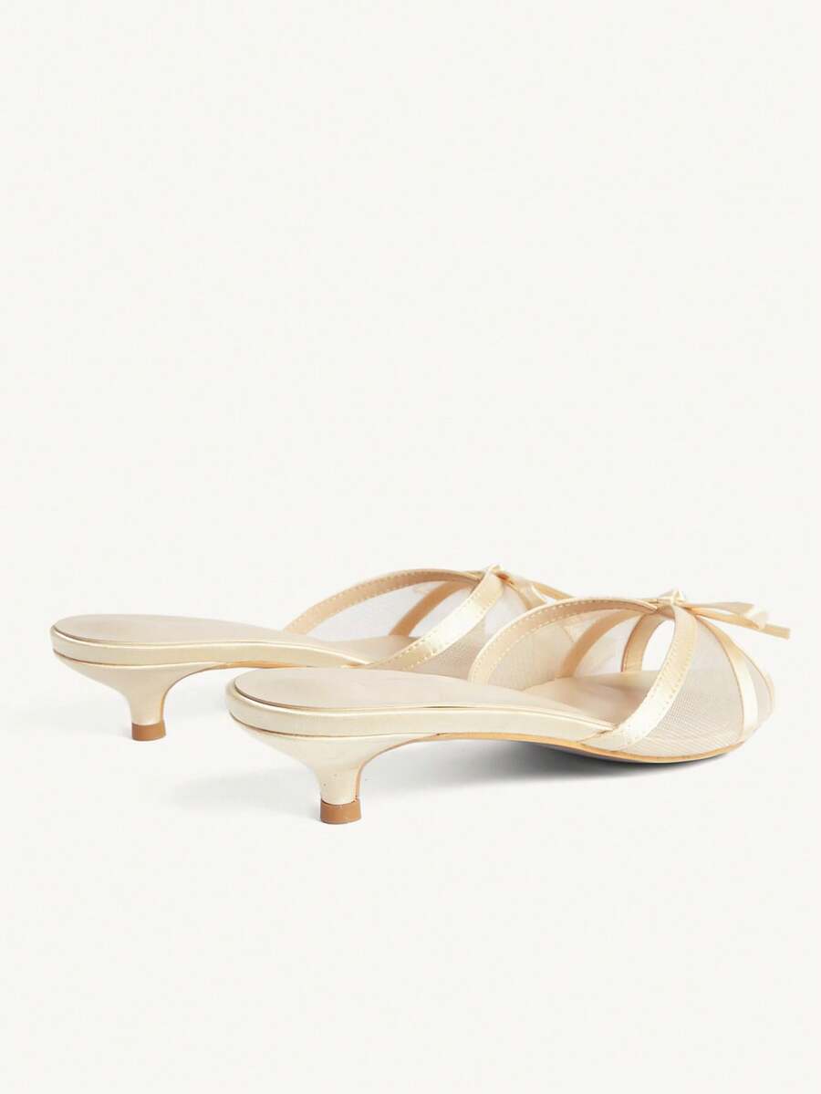 Pointed toe high-heeled slippers in PU leather with decorative buckle detail and low kitten heels for women.