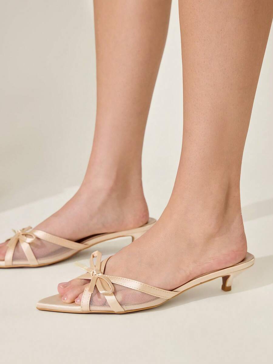 Pointed toe high-heeled slippers in PU leather with decorative buckle detail and low kitten heels for women.
