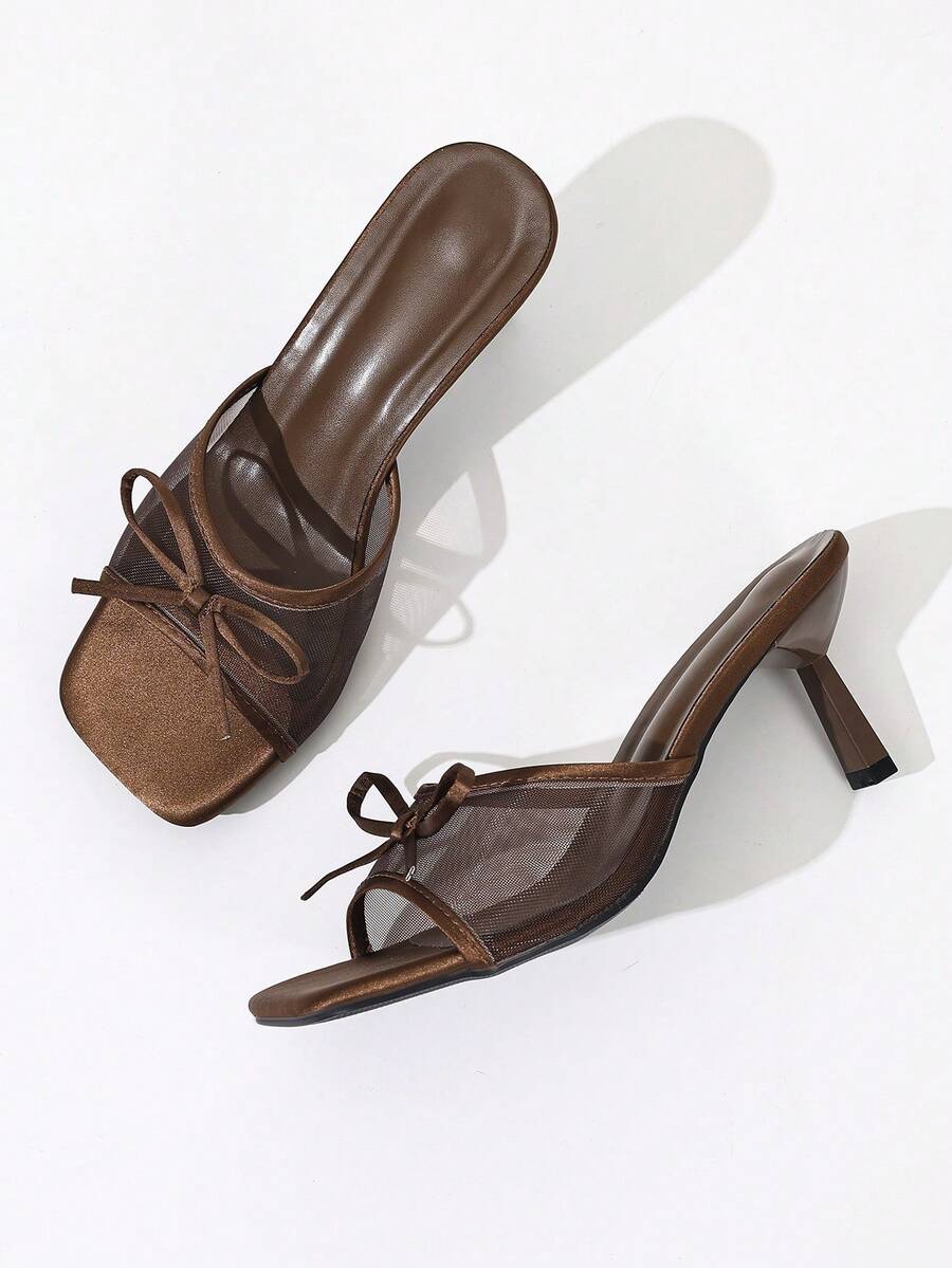 Women's black open toe mesh slide sandals with bowknot detail and stiletto heels