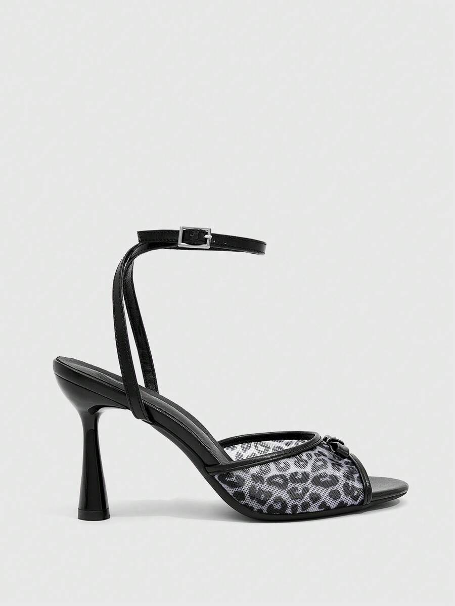 Pair of women's black high heel sandals with open toe design, slim stiletto heel, and adjustable ankle buckle strap.