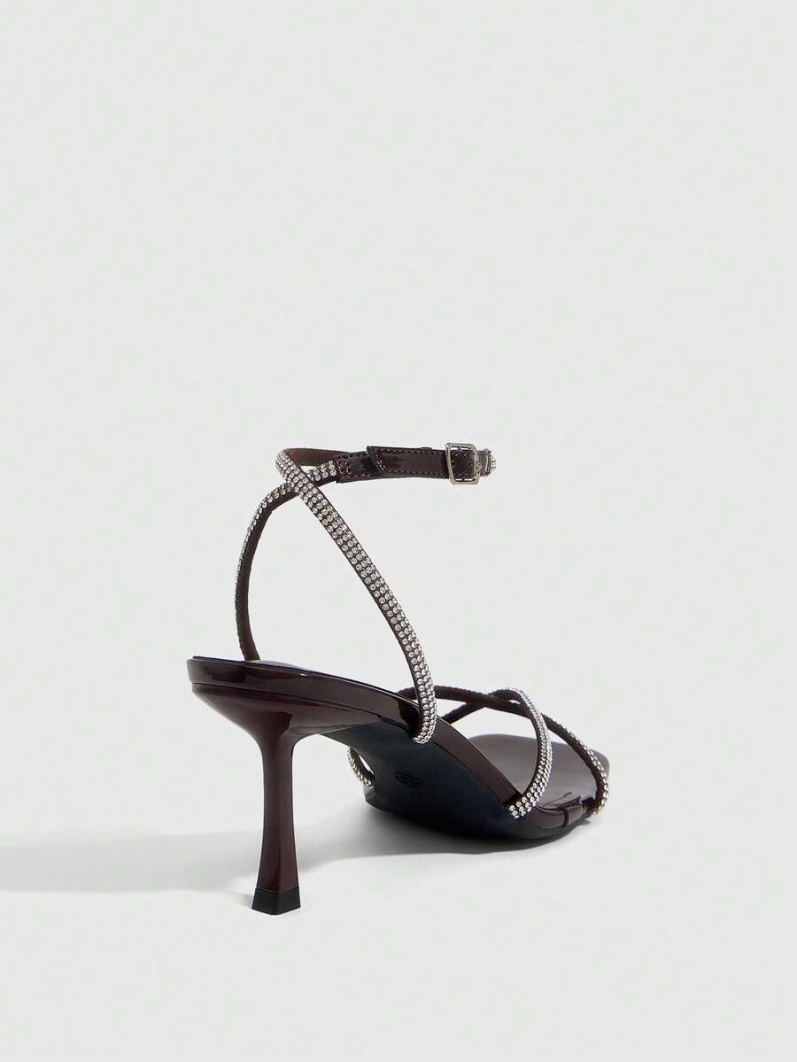Women's open toe stiletto heel sandals featuring square toe design, criss-cross rhinestone slim straps, and secure ankle strap.