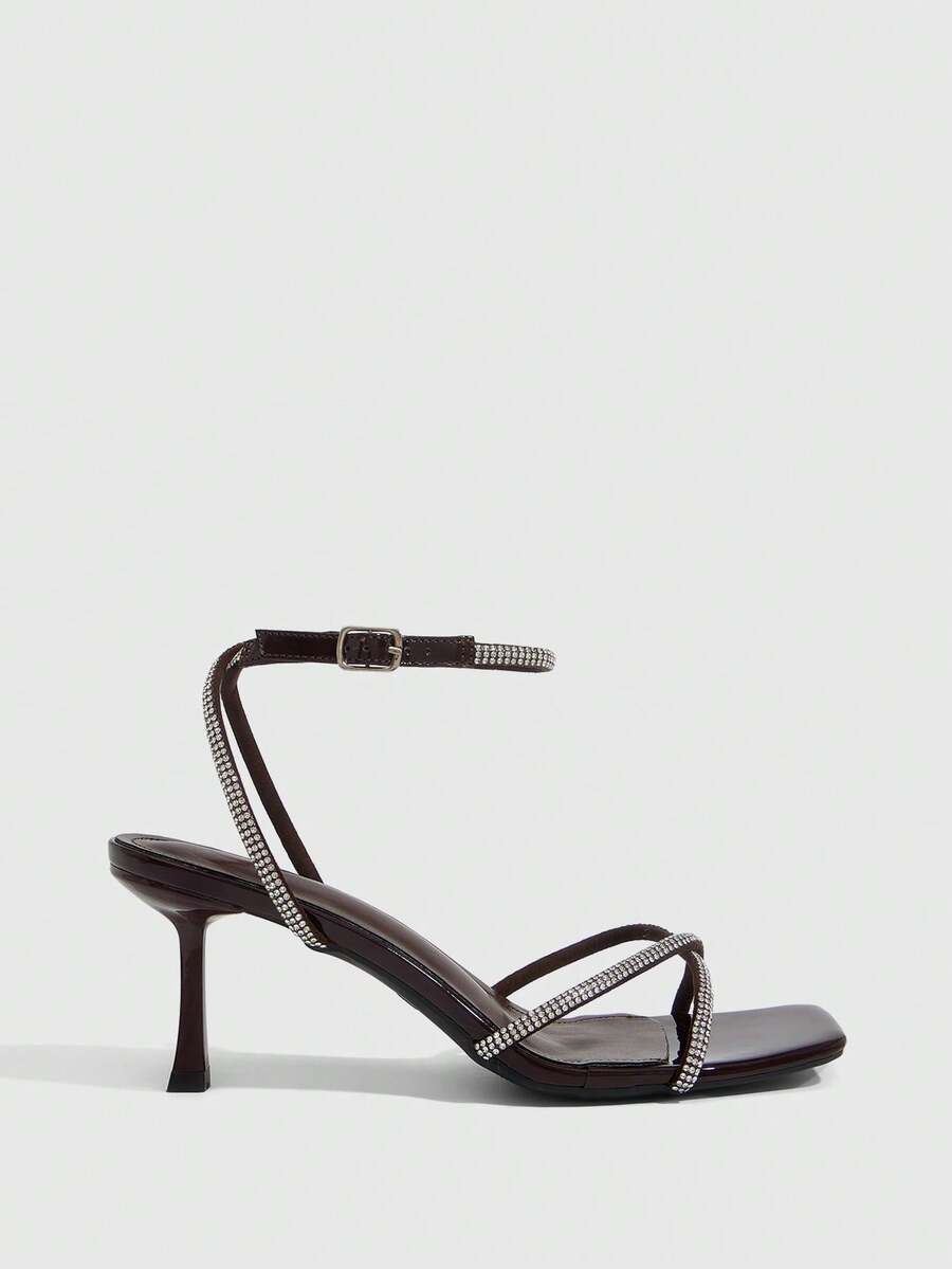Women's open toe stiletto heel sandals featuring square toe design, criss-cross rhinestone slim straps, and secure ankle strap.