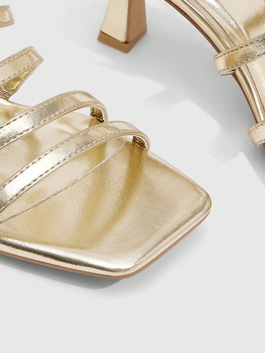 Women's metallic square toe Roman high heel sandals featuring cross straps and adjustable ankle buckle.
