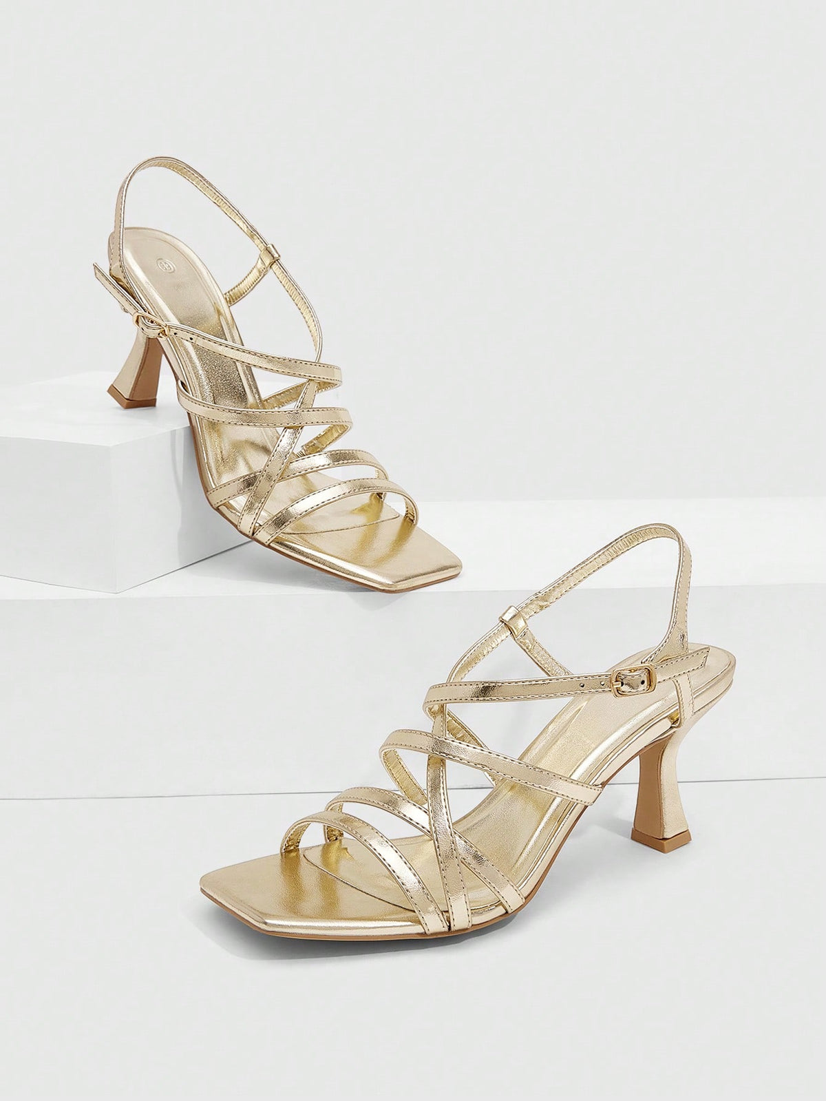 Women's metallic square toe Roman high heel sandals featuring cross straps and adjustable ankle buckle.