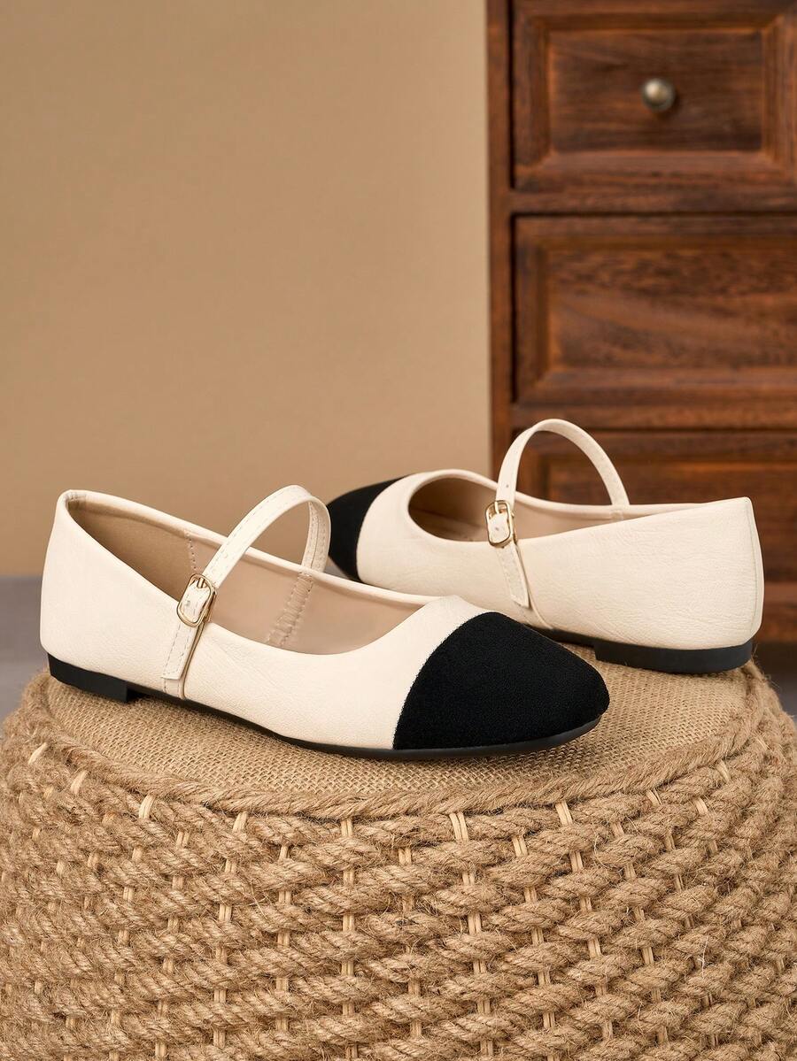 Pair of women's square toe slip-on flat shoes featuring a delicate bow detail and low vamp design.